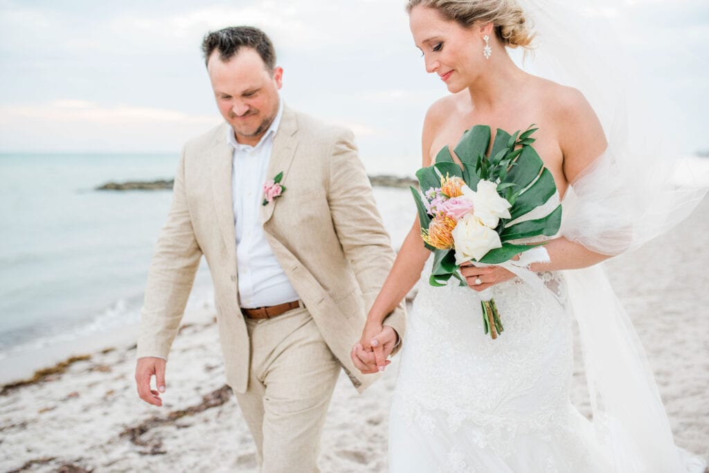 Walking hand in hand at a beach wedding