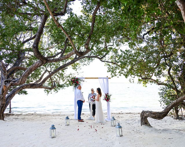 Beach Wedding at Bakers Cay Resort in Key Largo with Bamboo Arbor with white draping